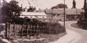 The Institute is on the left, looking down the Higham Road (B645) toward the Green.