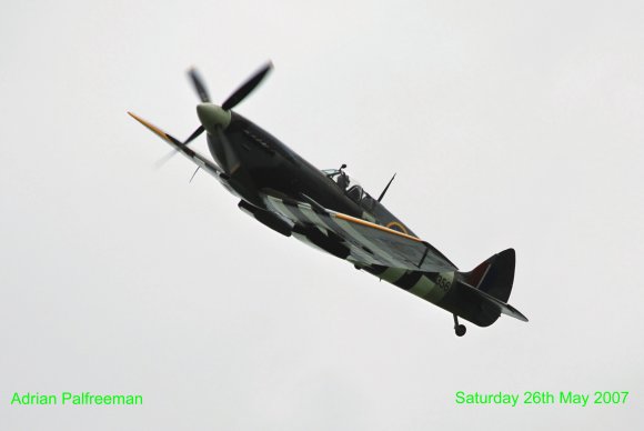 Spitfire flypast over the veterans on the airfield.